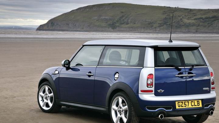 Side Back Pose Of Mini Cooper S In Blue Near Mountains N Sea